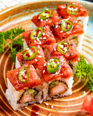 side view of tempura sushi maki with shrimp and avocado on a plate