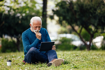 Mature man, relaxing alone while enjoying the nature.