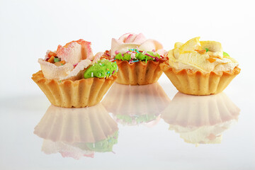 Three cakes , tartlet with cream