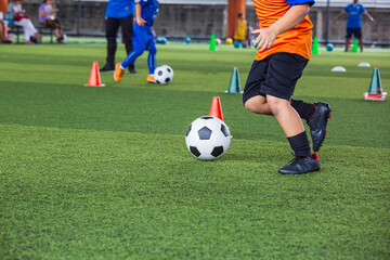 Obraz premium Children playing control soccer ball tactics on grass field with for training