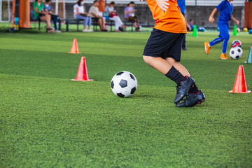 Children playing control soccer ball tactics on grass field with for training