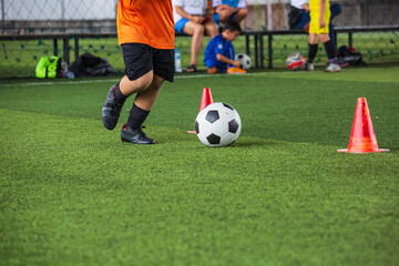 Obraz premium Children playing control soccer ball tactics on grass field with for training