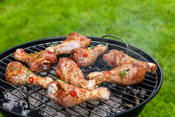 Chicken Drumstick Legs Grilling on Charcoal BBQ. Summer Picnic Food in Backyard Garden