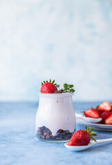 Natural yogurt with granola and strawberry for breakfast or snack. Healthy eating concept.