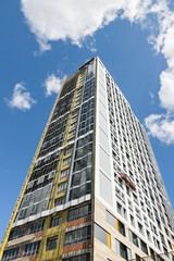 A high-rise building is under construction. metal and concrete structures. A sunny summer day.