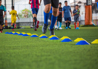 Soccer ball tactics on grass field with barrier for training children jump skill