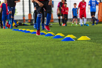 Soccer ball tactics on grass field with barrier for training children jump skill