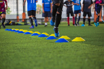 Soccer ball tactics on grass field with barrier for training children jump skill