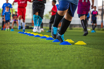 Soccer ball tactics on grass field with barrier for training children jump skill