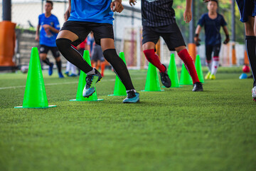 Soccer ball tactics on grass field with cone  for training children running