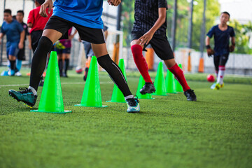 Soccer ball tactics on grass field with cone  for training children running