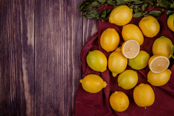 top view of fresh ripe lemons isolated on rustic background with copy space