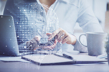 Double exposure of brain sketch hologram and woman holding and using a mobile device.