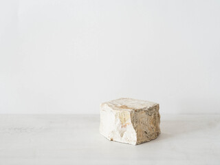 Grey natural stone podium on white background, platform for product display