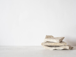 Grey natural stones podium on white background, platform for product display.