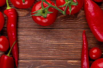 top view of fresh vegetables ripe tomatoes with red chili peppers on rustic wooden background with copy space