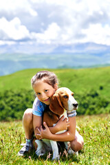 little funny girl with a dog in the mountains