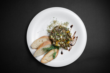 vegetable caviar or stew with eggplant, zucchini and bell pepper on white plate