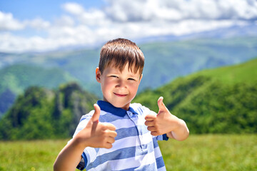a funny little boy shows the class and smiles