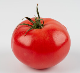Close up on a fresh perfect tomato isolated on white