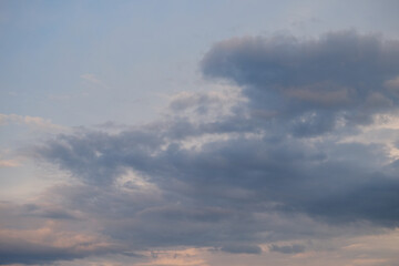 Obraz premium Cumulus clouds in the sky at sunset. Dramatic sky.