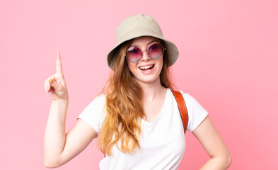 red head pretty woman tourist feeling like a happy and excited genius after realizing an idea