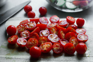Fresh cherry tomatoes cutted in halves. Healthy food, cooking at home.
