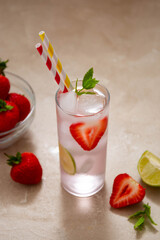 Strawberry cold drink with fresh berry, lime and mint. Summer cold drink with papper straw