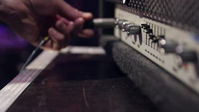 Jack audio connector is plugged into a socket on an audio device for music, audio.