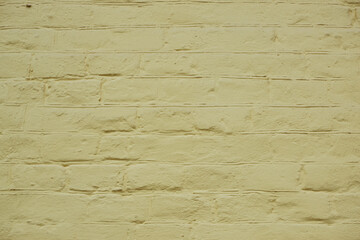 Pastel Background. Brick wall painted in yellow. Close up of a yellow painted brick wall background texture.