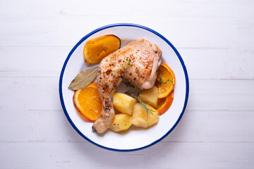 Chicken cooked with potatoes and orange sauce.
