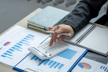 Financial Business man analyze the graph of the company's performance to create profits and growth,...