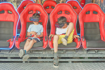 Two boys watching a video wearing virtual reality glasses.