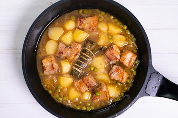 Pork stew with peas and potatoes. Traditional tapa from the north of Spain.