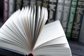 Open book on the background of books