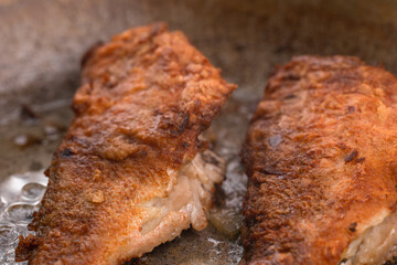 Fried fish in oil in a pan