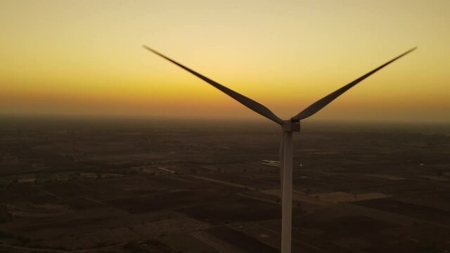 Aerial view over the farm landscape and wind turbines generating clean renewable energy. Renewable energy production for the green ecological world.
