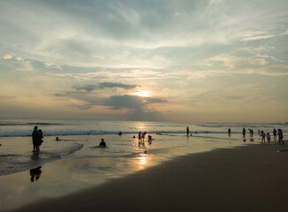 reflection of sunlight and shadows of people on petitenget beach, kerobokan, bali