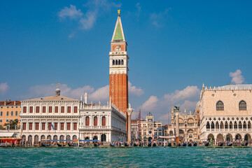 Fototapeta na wymiar Full size view of Campanile Bell Tower at San Marco square in Venice, Italy, at sunny day and deep blue sky.