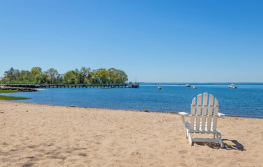 white adirondack chair on the beach