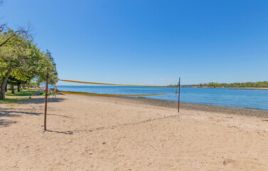 beach volleyball net on beach overlooking ocean