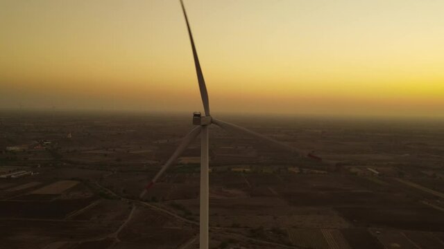 Aerial view over the farm landscape and wind turbines generating clean renewable energy. Renewable energy production for the green ecological world.