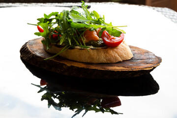 Italian tomato bruschetta with chopped vegetables, herbs and oil on grilled or toasted crusty...