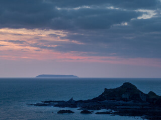 Fototapeta na wymiar Sunset view of Lundy island from Hartland beach. Devon, UK.