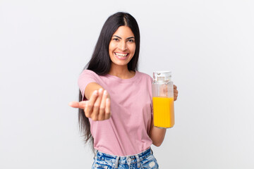 hispanic pretty woman. orange juice and breakfast concept