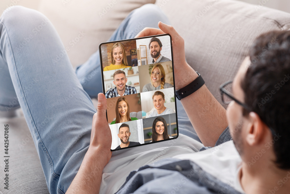 Aufkleber unrecognizable guy with digital tablet having group video call with friends
