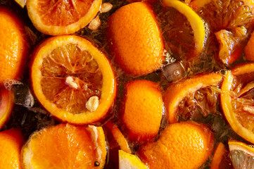 Chopped oranges with ice in wine. Sangria close up