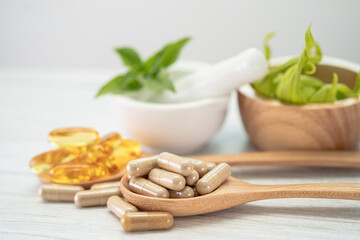 Alternative medicine herbal organic capsule with vitamin E omega 3 fish oil, mineral, drug with herbs leaf natural supplements for healthy good life.