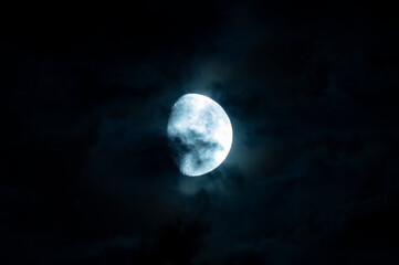 Clouds and spots on the moon. Moonlight in the black night sky