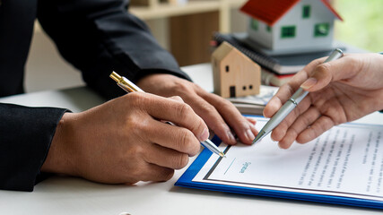 Sales agents offer home purchase contracts or discuss loans and interest rates, home buying and renting ideas.